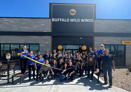 group of people celebrating the opening of buffalo wild wings